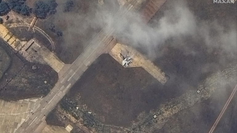 This image released by Maxar Technologies shows a damaged plane,...