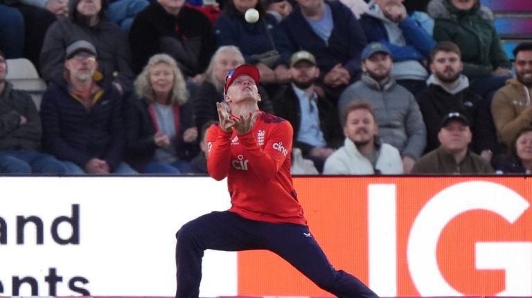 England's Jordan Cox catches out Australia's Travis Head during the...