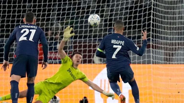 PSG's Kylian Mbappe, right, scores his side's first goal from...