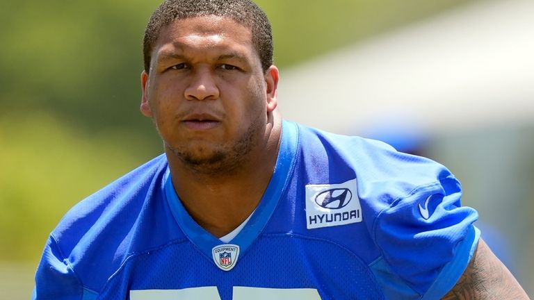 Los Angeles Rams offensive tackle Alaric Jackson runs drills after...