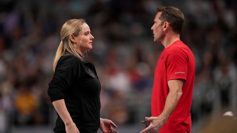 Cecile & Laurent Landi, coaches of Simone Biles, chat before...