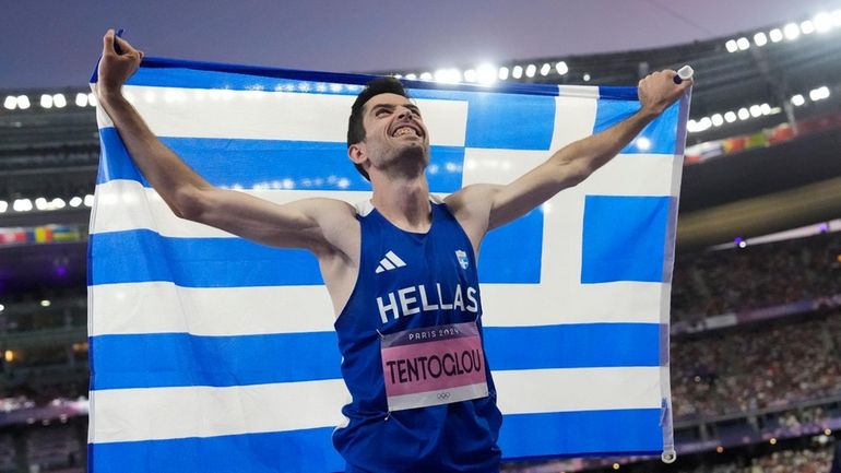 Miltiadis Tentoglou, of Greece, celebrates after winning the men's long...