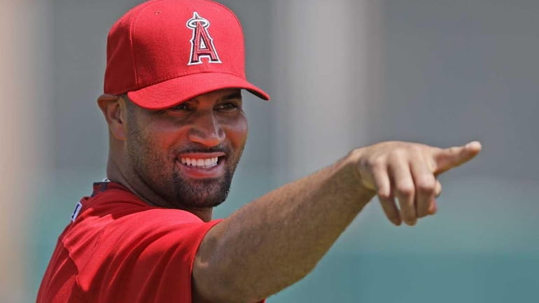 Los Angeles Angels' Albert Pujols signals to teammates in the...