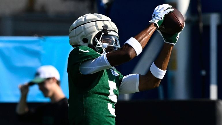 Jets wide receiver Garrett Wilson catches a pass during a joint...