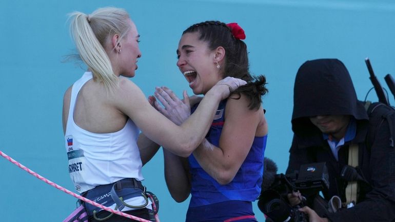 Gold medallist Janja Garnbret of Slovenia, left, congratulates silver medallist...