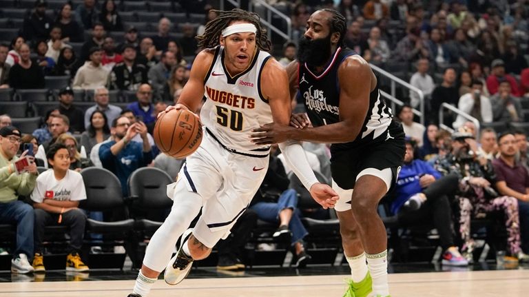 Denver Nuggets forward Aaron Gordon, left, drives against Los Angeles...