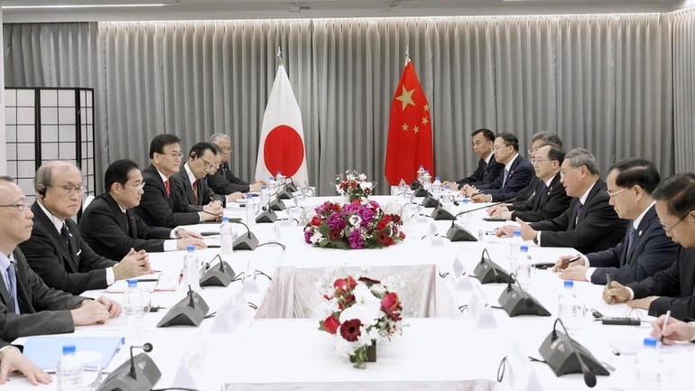 Japanese Prime Minister Fumio Kishida, third left, holds a meeting...