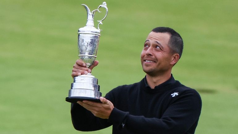 Xander Schauffele of the United States holds the Claret Jug...