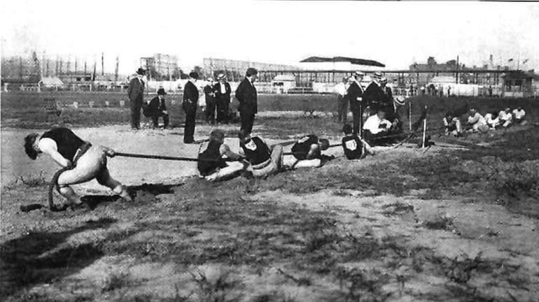 A tug-of-war competition at the 1904 Olympic Games in St....