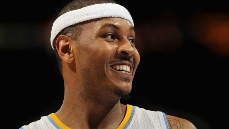 Carmelo Anthony #15 of the Denver Nuggets looks on during...