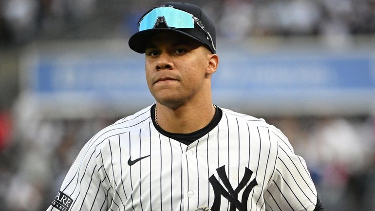 Yankees right fielder Juan Soto runs in from the outfield...