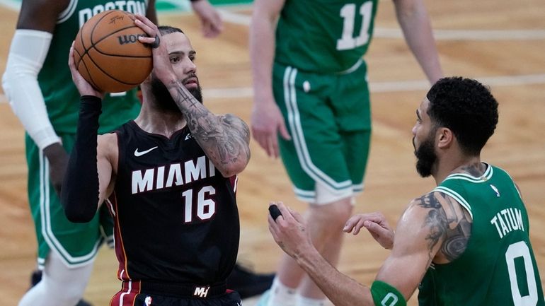 Miami Heat forward Caleb Martin (16) looks to pass while...