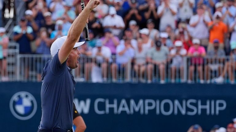 Keegan Bradley celebrates on the 18th green after winning the...