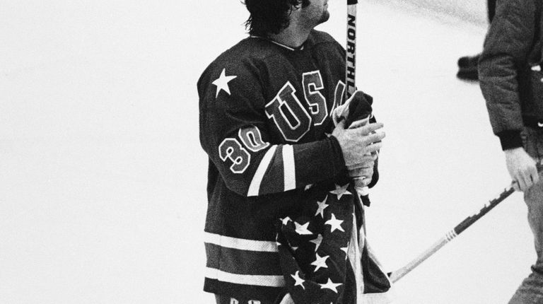 Jim Craig, goalie for the USA Olympic hockey team, holds...