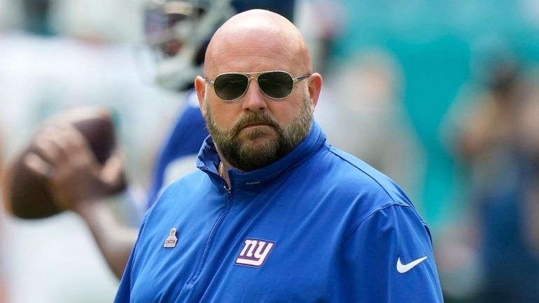 Giants head coach Brian Daboll watches his team warm up...