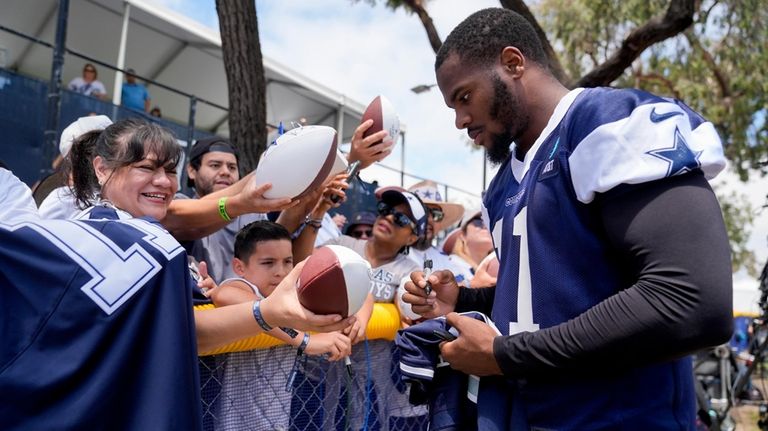 Dallas Cowboys linebacker Micah Parsons signs autographs during NFL football...