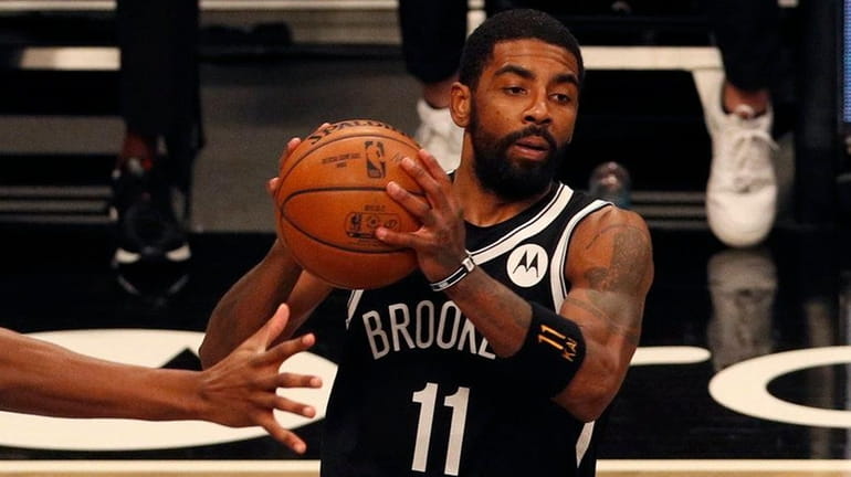 Kyrie Irving of the Nets controls the ball in the first...