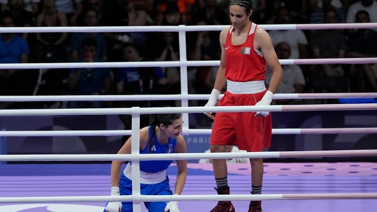 Algeria's Imane Khelif, right, defeated, Italy's Angela Carini in their...