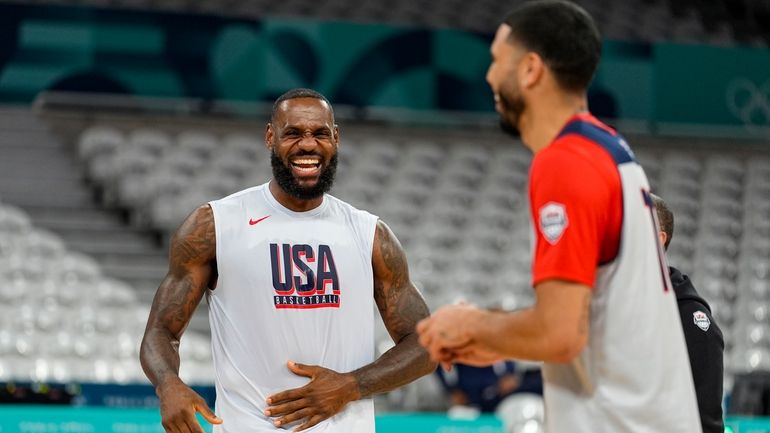 LeBron James, jokes with Jayson Tatum, as the United State's...