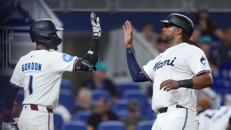 Miami Marlins' Josh Bell, right, is congratulated by Nick Gordon...