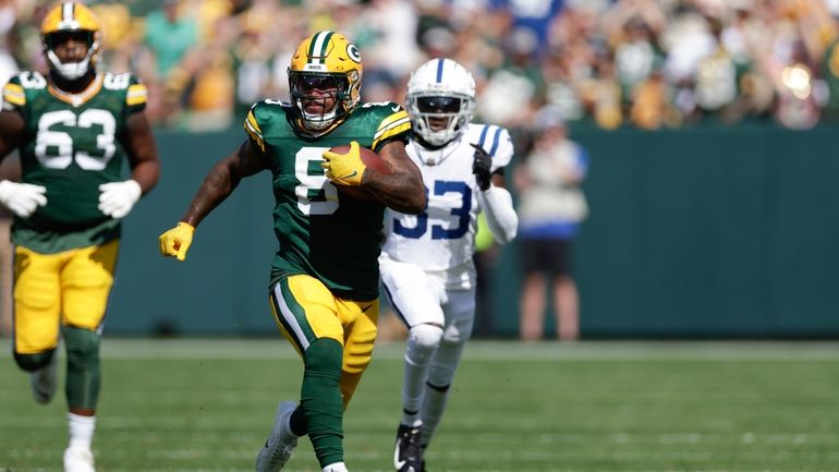 Green Bay Packers running back Josh Jacobs (8) runs for...