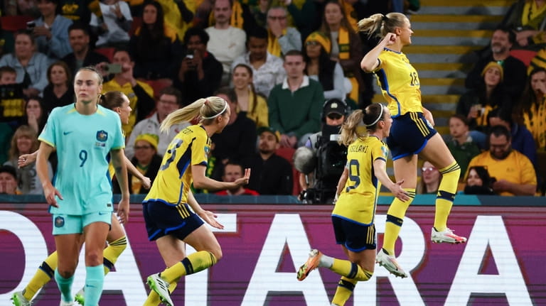 Sweden's Fridolina Rolfo, right, celebrates after scoring her team's first...