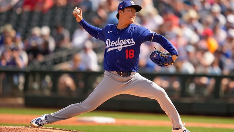 Los Angeles Dodgers starting pitcher Yoshinobu Yamamoto throws against the...