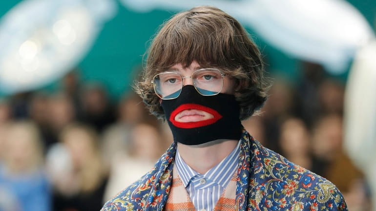 A model wears a creation as part of the Gucci...
