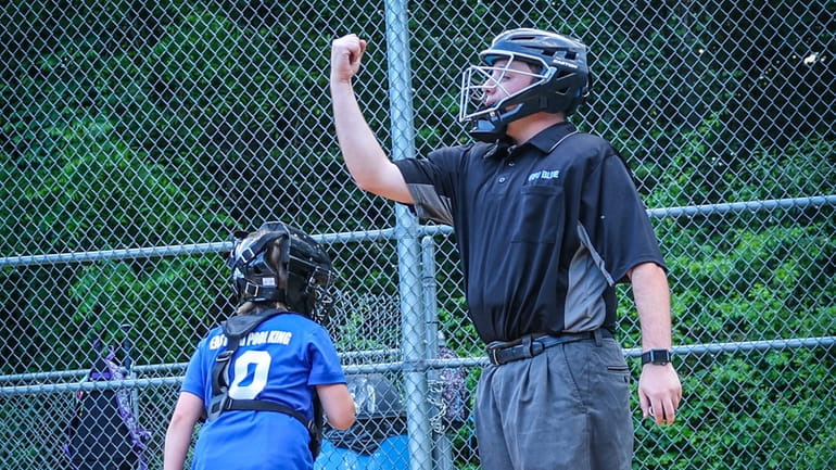 Umpire Justin Wheeler officiating a little league game in Manorville...