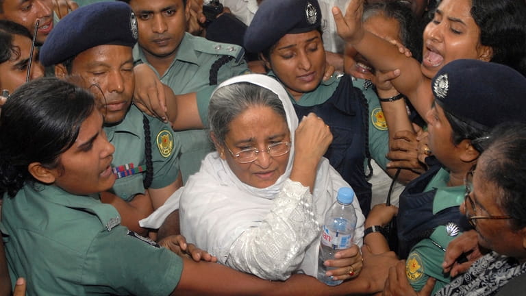FILE- Police escort former Bangladeshi Prime Minister and Awami League...