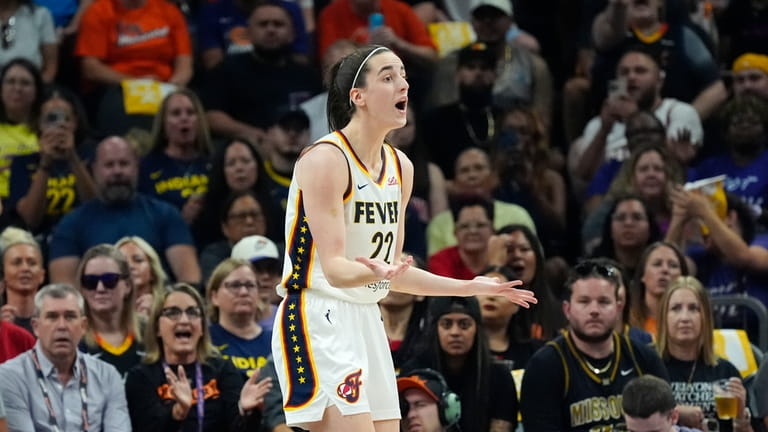 Indiana Fever guard Caitlin Clark reacts after being called for...