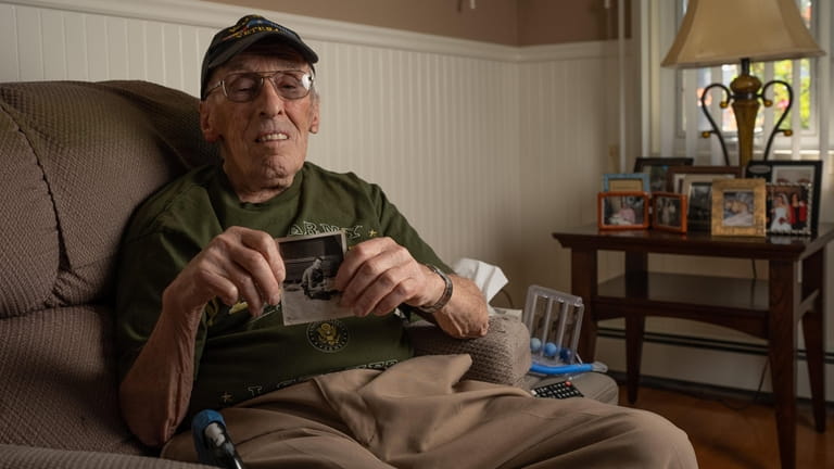 Herb Gold, 90, of Levittown holds a photograph of his...