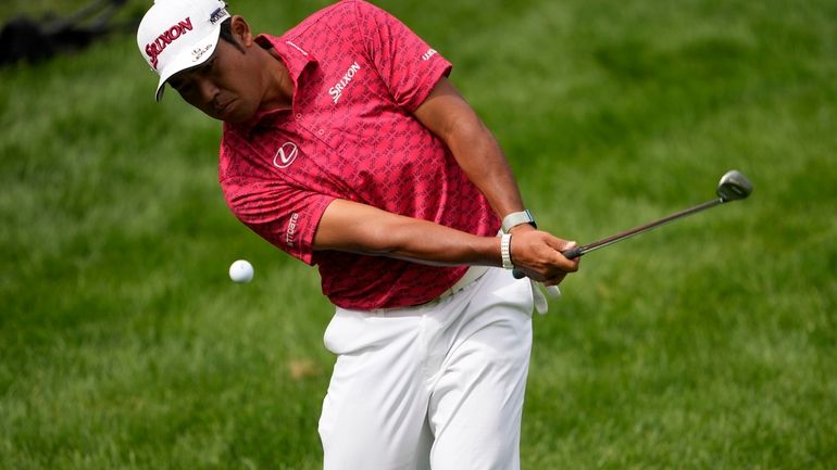 Hideki Matsuyama, of Japan, chips onto the 17th green during...