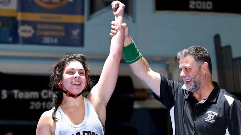 Hills East's Sophia Boggio has her hand raised after defeating...