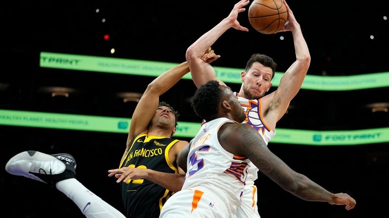 Phoenix Suns forward Drew Eubanks rebounds over Golden State Warriors...