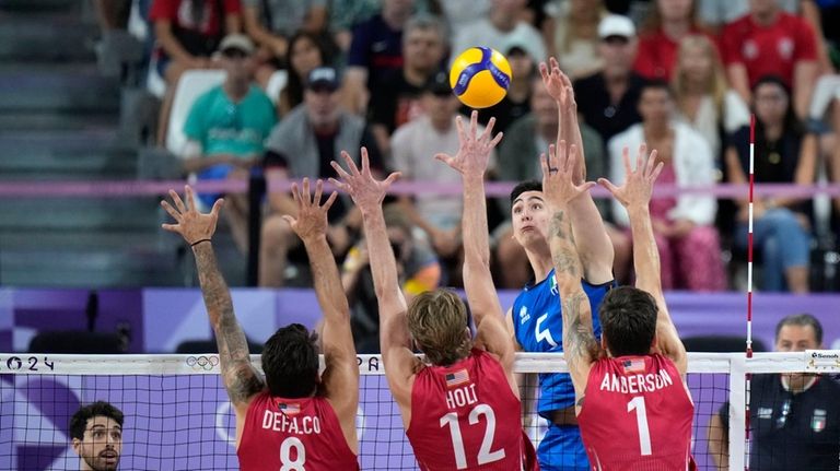 Alessandro Michieletto, of Italy, spikes a ball during a men's...