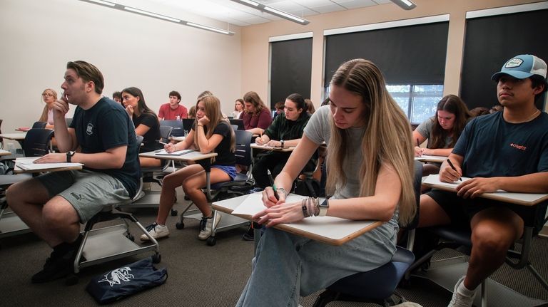 Audra Hillman, 18, foreground right, a freshman at the University...