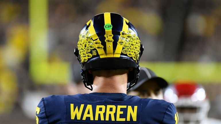 Michigan quarterback Davis Warren prepares to hike the ball against...