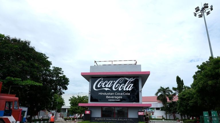 Security staff stand in front of the Hindustan Coca-Cola Beverages...