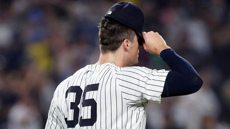 Clay Holmes of the New York Yankees reacts after surrendering...