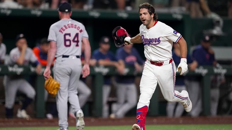 Texas Rangers' Josh Smith, right, runs the bases after hitting...