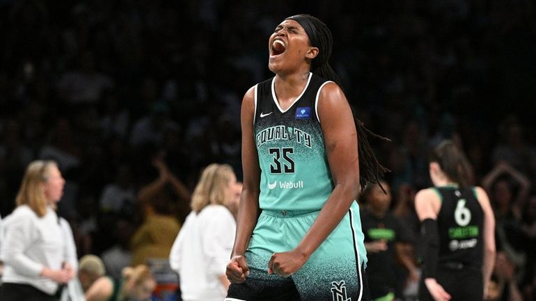 Liberty forward Jonquel Jones reacts after scoring a basket against...