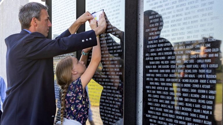 FDNY member Liam Grieve, of East Islip, with his daughter...