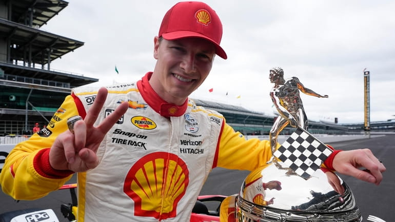 Josef Newgarden poses with the Borg-Warner Trophy during the traditional...