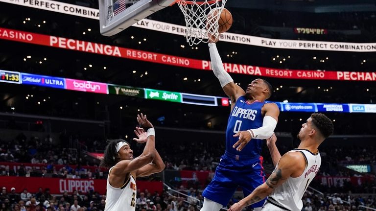 Los Angeles Clippers guard Russell Westbrook, center, shoots against Denver...