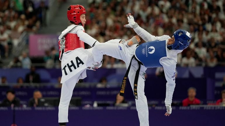 Saudi Arabia's Dunya Ali M Abutaleb competes with Thailand's Panipak...