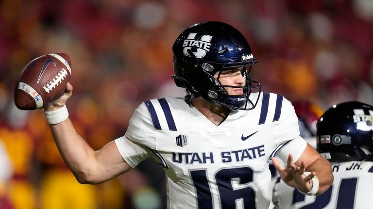 Utah State quarterback Bryson Barnes passes during the second half...