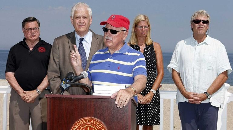 New York State Senator Ken LaValle (center), along with, from...