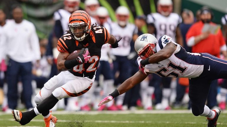 BenJarvus Green-Ellis of the Cincinnati Bengals breaks a tackle attempt...