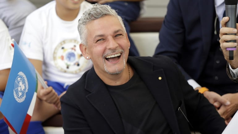 Italian soccer legend Roberto Baggio smiles as he attends an...